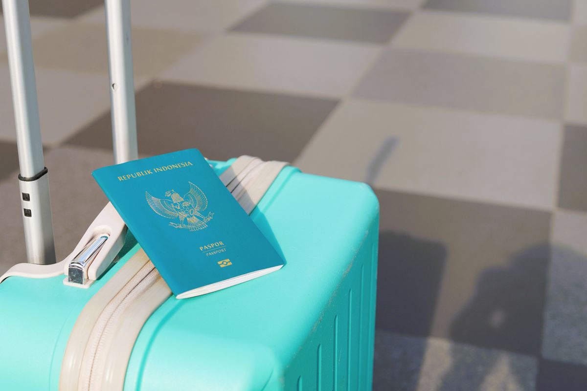 Indonesian passport resting on a suitcase